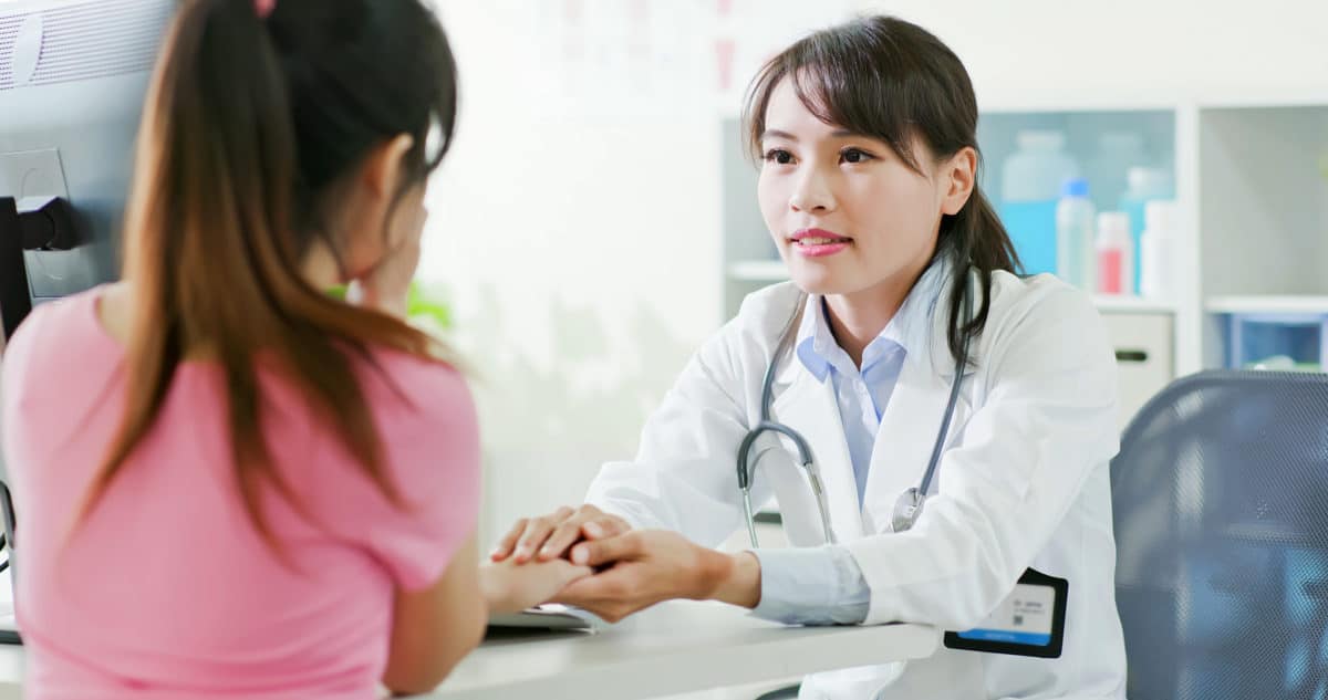 Government Scrutiny on Opioids doctor consoling her patient in her office