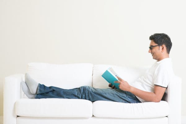 Common Mistakes in Pain Management man distracting himself from pain by reading